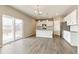 Modern kitchen features white cabinets, stainless steel appliances, and center island for gathering at 2206 Crosswind St, Fort Lupton, CO 80621