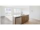 Modern kitchen island with stainless steel appliances and white countertops at 13412 E 110Th Way, Commerce City, CO 80022