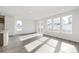 Sunlit living room with hardwood floors and large windows at 13412 E 110Th Way, Commerce City, CO 80022