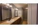 Bathroom featuring a double sink vanity, mirrors, and a shower and tub at 1653 Valley Oak Ct, Castle Rock, CO 80104