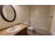 Well-lit bathroom featuring a single sink, tile flooring, and a shower and bathtub combination at 1653 Valley Oak Ct, Castle Rock, CO 80104
