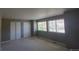 Bedroom showcasing large windows, sliding door closet, and neutral tones at 1653 Valley Oak Ct, Castle Rock, CO 80104