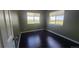 Cozy bedroom featuring bright windows with a scenic view and beautiful dark wood flooring at 1653 Valley Oak Ct, Castle Rock, CO 80104