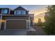 Lovely home with two-car garage, gravel landscaping and a scenic sunset view at 1653 Valley Oak Ct, Castle Rock, CO 80104