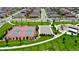 Aerial view of neighborhood amenities, including a tennis court, basketball court, and playground at 16341 Clayton St, Thornton, CO 80602