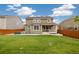 Spacious backyard with green grass, fence, solar panels, and covered patio, perfect for outdoor enjoyment and gatherings at 16341 Clayton St, Thornton, CO 80602