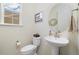 Stylish half bathroom with a pedestal sink and a window offering natural light at 16341 Clayton St, Thornton, CO 80602