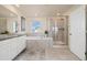 Elegant bathroom features a large soaking tub and a glass-enclosed shower at 16341 Clayton St, Thornton, CO 80602