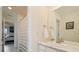 Bright bathroom featuring a marble countertop vanity and a shower with a striped curtain at 16341 Clayton St, Thornton, CO 80602