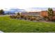 Stone community sign with 'Orchard Farms' lettering, set amidst lush landscaping and green lawns at 16341 Clayton St, Thornton, CO 80602
