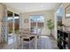 Bright dining room featuring large windows, a sliding glass door, and a stylish rug at 16341 Clayton St, Thornton, CO 80602