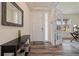 Inviting entryway with wood floors, a stylish console table, and a view into a bright office at 16341 Clayton St, Thornton, CO 80602