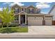 Charming two-story home with a well-maintained lawn and a three-car garage at 16341 Clayton St, Thornton, CO 80602