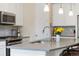 Beautiful kitchen with stainless steel appliances, a stylish faucet, and modern gray countertop at 16341 Clayton St, Thornton, CO 80602