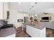 Modern kitchen with white cabinets, stainless steel appliances, and a kitchen island at 16341 Clayton St, Thornton, CO 80602