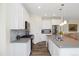Modern kitchen featuring white cabinets, stainless steel appliances, and a center island at 16341 Clayton St, Thornton, CO 80602