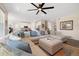 Open-concept living room with a large sectional sofa, and view into the kitchen at 16341 Clayton St, Thornton, CO 80602
