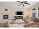 Comfortable living room with a fireplace, a large sectional, and bright windows at 16341 Clayton St, Thornton, CO 80602