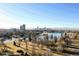 Scenic aerial view of a park with a lake and city skyline in the background, capturing the beauty and serenity of the location at 384 S Decatur St, Denver, CO 80219