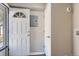 Clean entryway with white walls, light gray floor, with a door and access to the laundry hookups at 384 S Decatur St, Denver, CO 80219