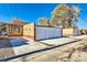 Detached three car garage with a large driveway and street access, providing ample parking and storage space at 384 S Decatur St, Denver, CO 80219