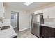 Bright kitchen featuring stainless steel appliances, a double sink, and ample counter space for meal preparation at 384 S Decatur St, Denver, CO 80219