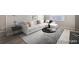 Bright living room with a large white sectional sofa, modern coffee table, and natural light from a window at 384 S Decatur St, Denver, CO 80219