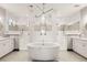 This spacious bathroom features dual vanities, a soaking tub, and tiled glass enclosed showers at 16370 Graham Peak Way, Broomfield, CO 80023