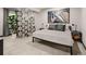 Minimalist bedroom with neutral tones, abstract art, and decorative screen at 16370 Graham Peak Way, Broomfield, CO 80023