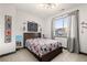 This cozy bedroom features comic book decor, a comfortable bed, and a large window at 16370 Graham Peak Way, Broomfield, CO 80023