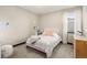 This bright bedroom features a comfortable bed, plush accents, and ample natural light at 16370 Graham Peak Way, Broomfield, CO 80023