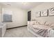 This cozy bedroom features a large window, comfortable bed, and light and airy decor at 16370 Graham Peak Way, Broomfield, CO 80023