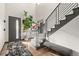Bright entryway with modern staircase, stylish rug, and ample natural light at 16370 Graham Peak Way, Broomfield, CO 80023
