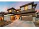 Stunning modern home featuring stone accents, a two-car garage, and professional landscaping at 16370 Graham Peak Way, Broomfield, CO 80023