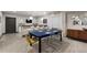 Game room features a bar with seating and a blue felt poker table with clear chairs at 16370 Graham Peak Way, Broomfield, CO 80023