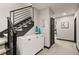 Hallway featuring modern floating stairs, a decorative white cabinet, and artwork at 16370 Graham Peak Way, Broomfield, CO 80023