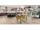 Open-concept kitchen and dining area with modern lighting, an island, and seamless access to outdoor space at 16370 Graham Peak Way, Broomfield, CO 80023
