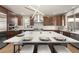 Gourmet kitchen with a large island, pendant lighting, and stainless steel appliances at 16370 Graham Peak Way, Broomfield, CO 80023