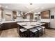 Elegant kitchen with a large center island, modern lighting, and stainless steel appliances at 16370 Graham Peak Way, Broomfield, CO 80023