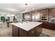 Gourmet kitchen featuring a large island with white countertop, stainless steel appliances, and custom cabinetry at 16370 Graham Peak Way, Broomfield, CO 80023