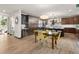 Modern kitchen with sleek dark cabinets, stainless steel appliances, and a stylish dining area at 16370 Graham Peak Way, Broomfield, CO 80023