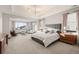 Spacious main bedroom featuring modern décor, a large bed, and plenty of natural light at 16370 Graham Peak Way, Broomfield, CO 80023