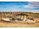 Community park featuring a shaded picnic area, playground, and open space with neighborhood homes in the background at 16370 Graham Peak Way, Broomfield, CO 80023