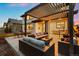 Relaxing outdoor patio featuring comfortable seating, dining area, and metal pergola at 16370 Graham Peak Way, Broomfield, CO 80023