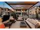 Cozy outdoor patio with sectional seating under a modern pergola at 16370 Graham Peak Way, Broomfield, CO 80023