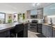 Modern kitchen boasting stainless steel appliances, sleek cabinets, subway tile, and urban views in a sunlit open space at 1301 Speer Blvd # 1108, Denver, CO 80204