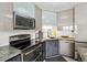 Modern kitchen featuring stainless steel appliances, stylish cabinets, and a breakfast bar, perfect for urban living at 1301 Speer Blvd # 1108, Denver, CO 80204