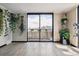 Living room features sliding doors to balcony, hardwood floors, and decorative plants at 1301 Speer Blvd # 1108, Denver, CO 80204