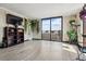 Bright living room with hardwood floors, large sliding glass doors to balcony, and decorative plants at 1301 Speer Blvd # 1108, Denver, CO 80204