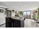 Stylish kitchen open to living room with breakfast bar and large windows offering stunning city views at 1301 Speer Blvd # 1108, Denver, CO 80204
